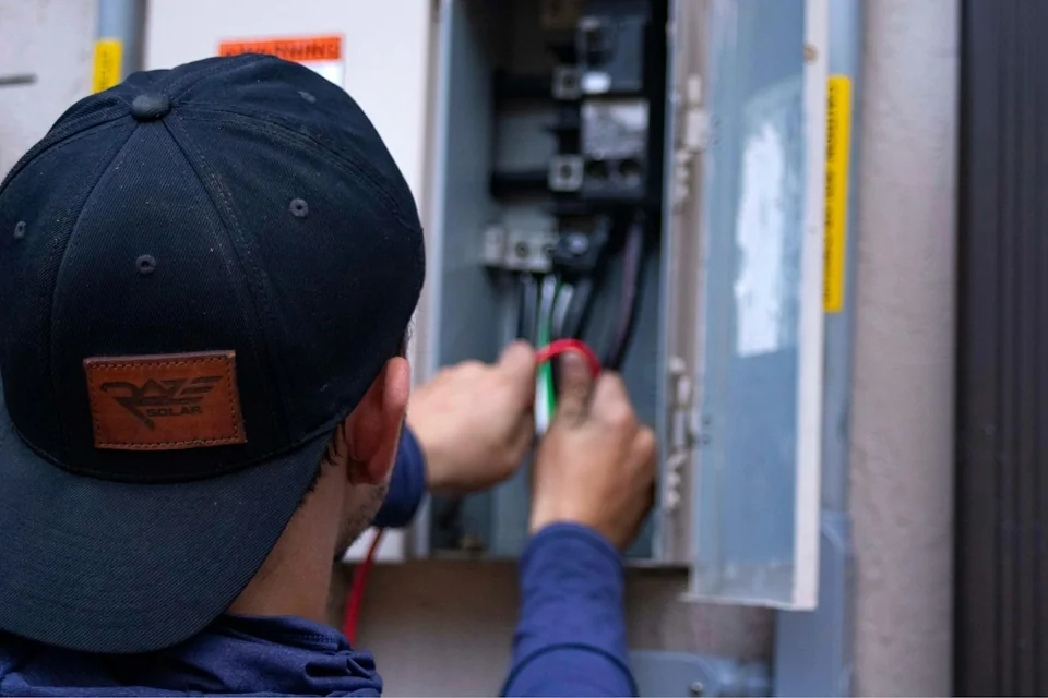 Electrician working on a panel at a customer’s home