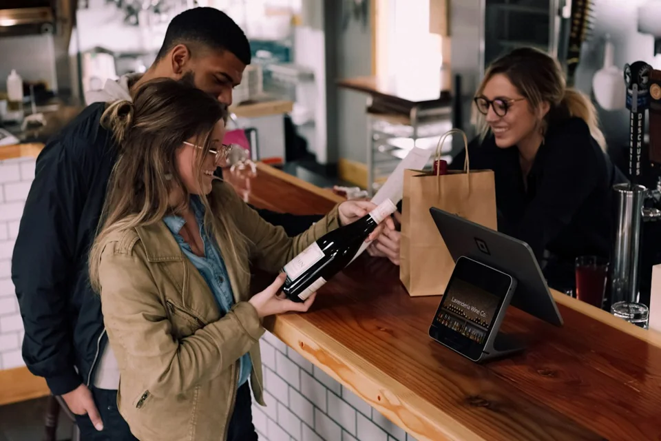 Staff helping a customer at a restaurant counter